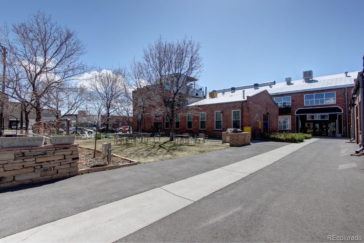 3377 Blake Street, Unit 202 Denver, CO 80205 - Photo 18 of 19 a view of a house with a yard and sitting area