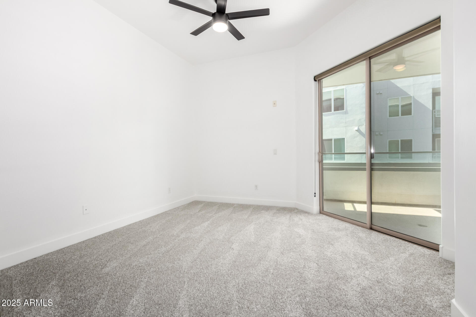 945 East Playa Del Norte Drive, Unit 4020 Tempe, AZ 85288 - Photo 20 of 39 an empty room with sliding glass door