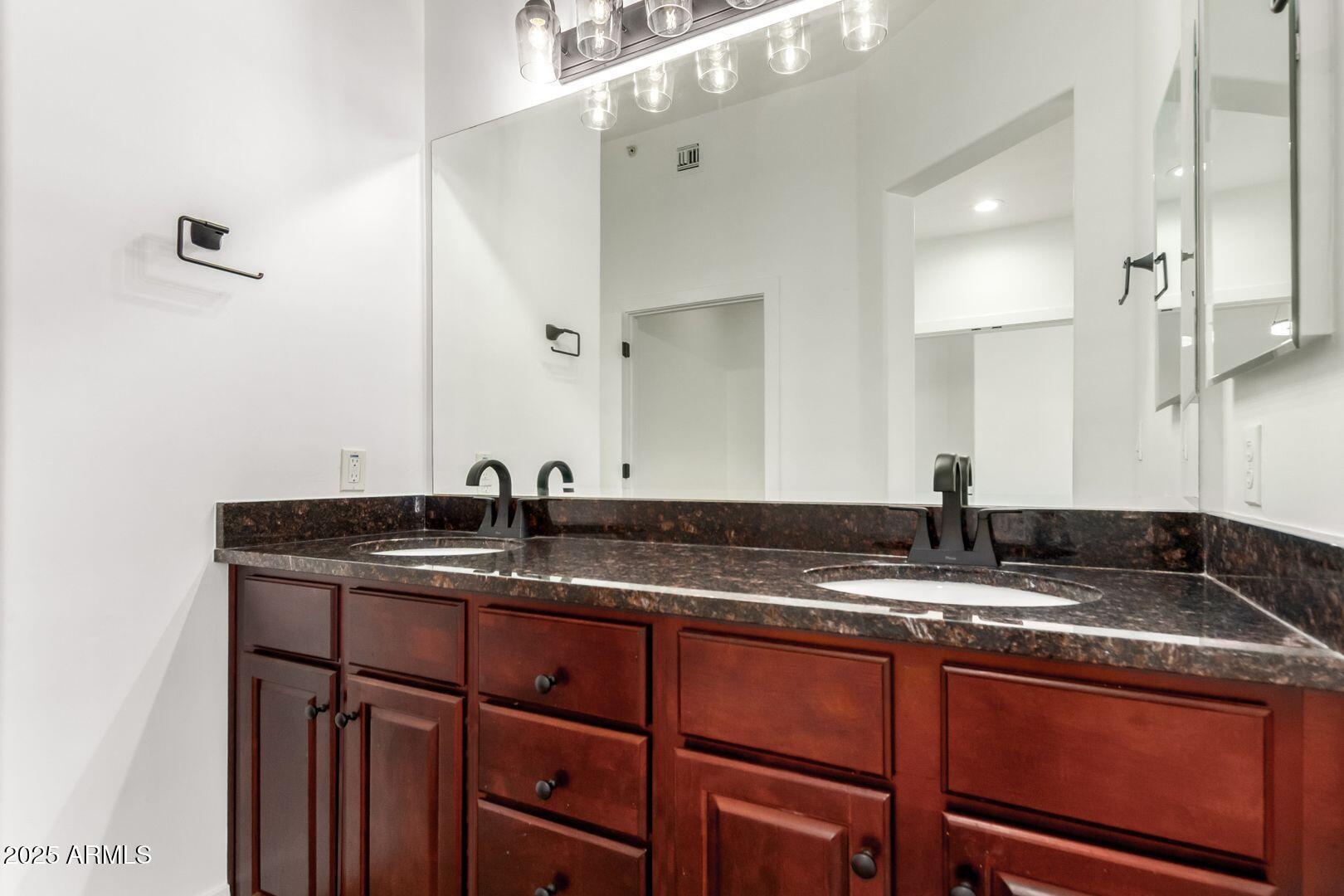945 East Playa Del Norte Drive, Unit 4020 Tempe, AZ 85288 - Photo 22 of 39 a bathroom with a granite countertop sink and a mirror