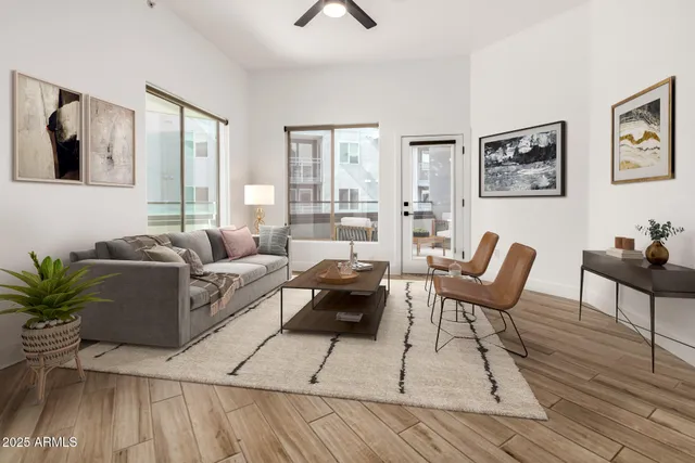 a living room with furniture and wooden floor