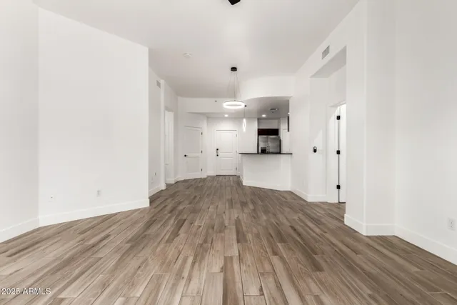 a view of a kitchen with wooden floor and a sink