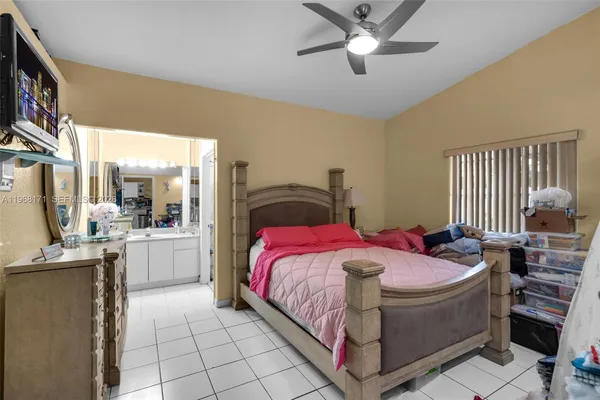 a bed room with a bed and a chandelier