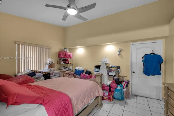 a bed room with a bed mirror and a window