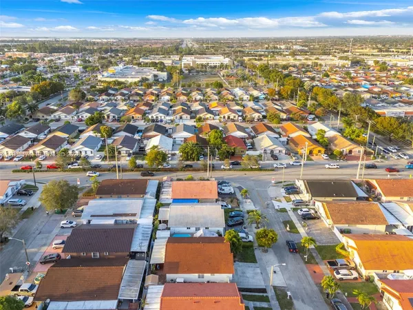 an aerial view of residential houses with outdoor space