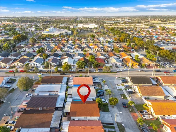 an aerial view of residential houses with outdoor space