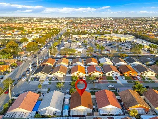 an aerial view of residential houses with city view