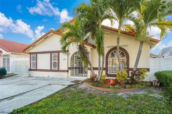 a front view of a house with a garden