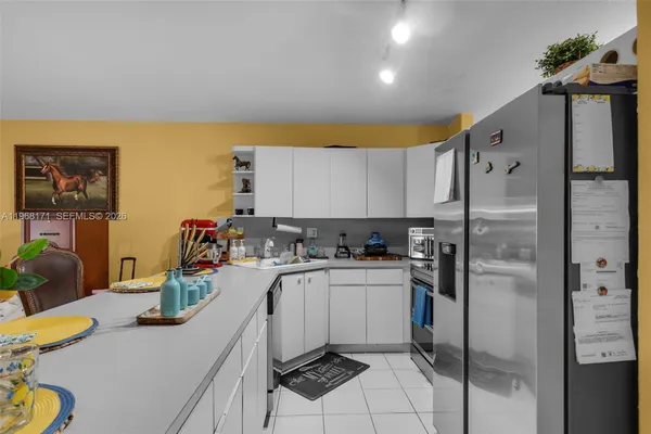 a kitchen with a sink appliances and cabinets