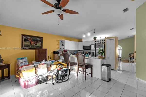 a view of a livingroom with furniture and a ceiling fan