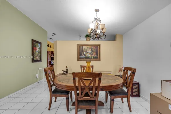 a view of a dining room with furniture and chandelier