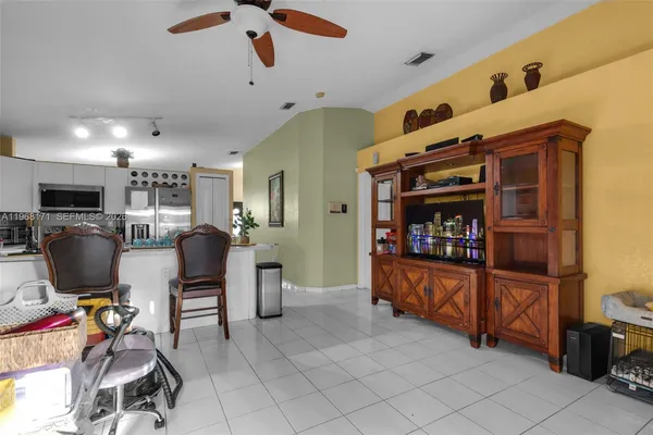 a view of a livingroom with workspace and a window