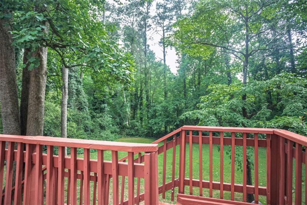 3838 Hunting Ridge Drive Southwest Lilburn, GA 30047 - Photo 51 of 56 a view of a roof deck with wooden fence and trees