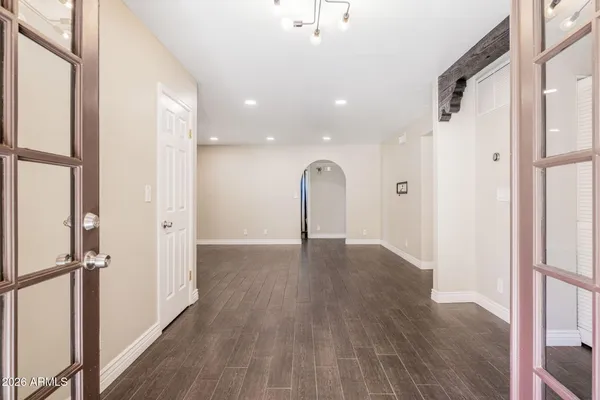 a view of empty room with wooden floor