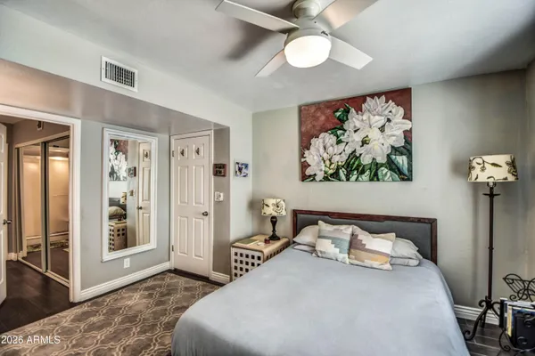a bedroom with bed and glass door