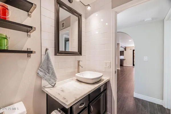 a bathroom with a sink a toilet and a mirror