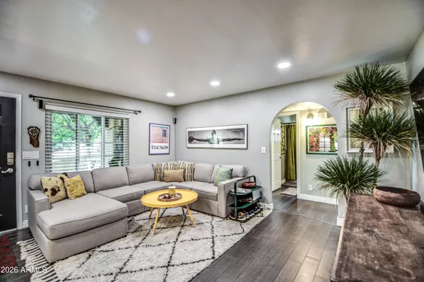 a living room with furniture potted plant and a large window