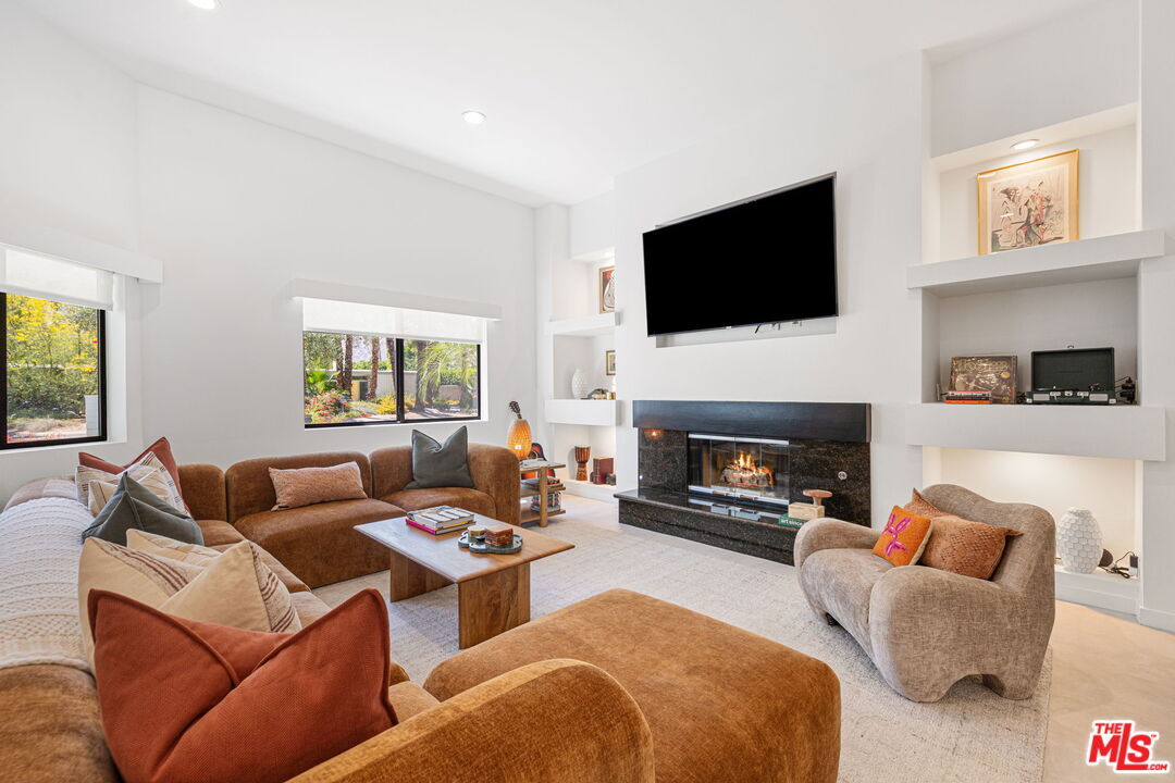 1414 Sagebrush Road Palm Springs, CA 92264 - Photo 13 of 48 a living room with furniture a flat screen tv and a fireplace