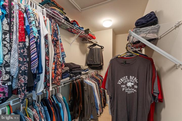 20900 Trinity Square Sterling, VA 20165 - Photo 22 of 38 a view of walk in closet with clothes