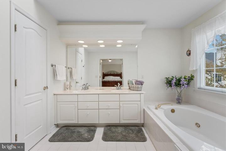 20900 Trinity Square Sterling, VA 20165 - Photo 24 of 38 a spacious bathroom with a tub sink and mirror