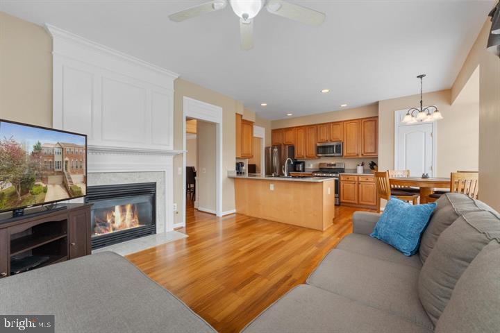 20900 Trinity Square Sterling, VA 20165 - Photo 10 of 38 a living room with stainless steel appliances furniture fireplace and flat screen tv