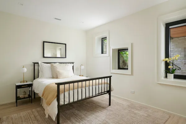 a bedroom with a bed and a painting on the wall