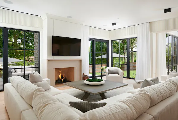 a living room with furniture fireplace and large window
