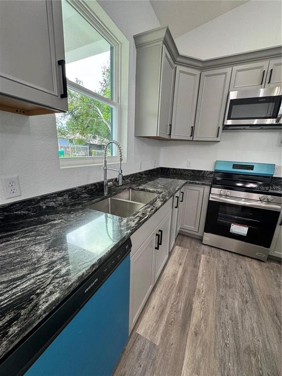 5394 Northwest 6th Place Ocala, FL 34482 - Photo 12 of 42 a kitchen with granite countertop a sink cabinets and stainless steel appliances
