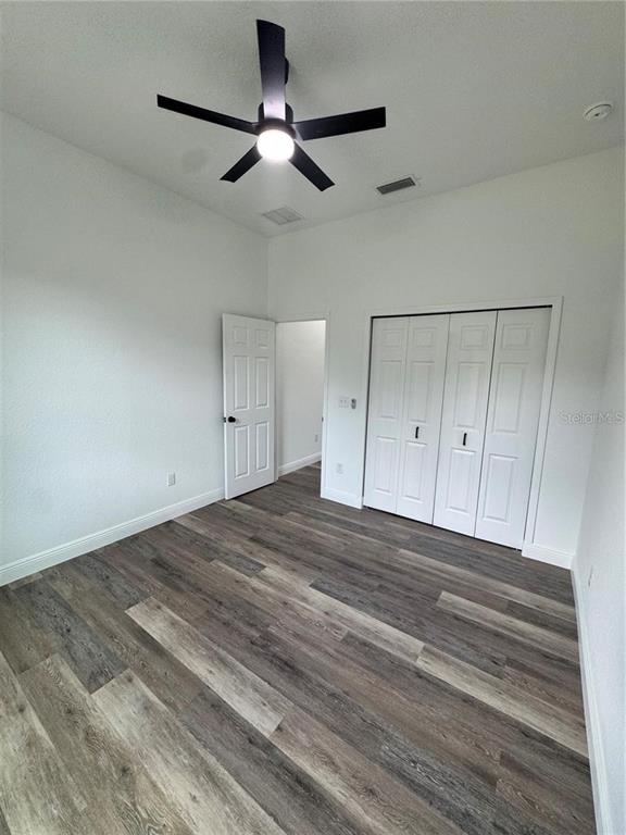 5394 Northwest 6th Place Ocala, FL 34482 - Photo 18 of 42 a view of empty room with wooden floor and fan