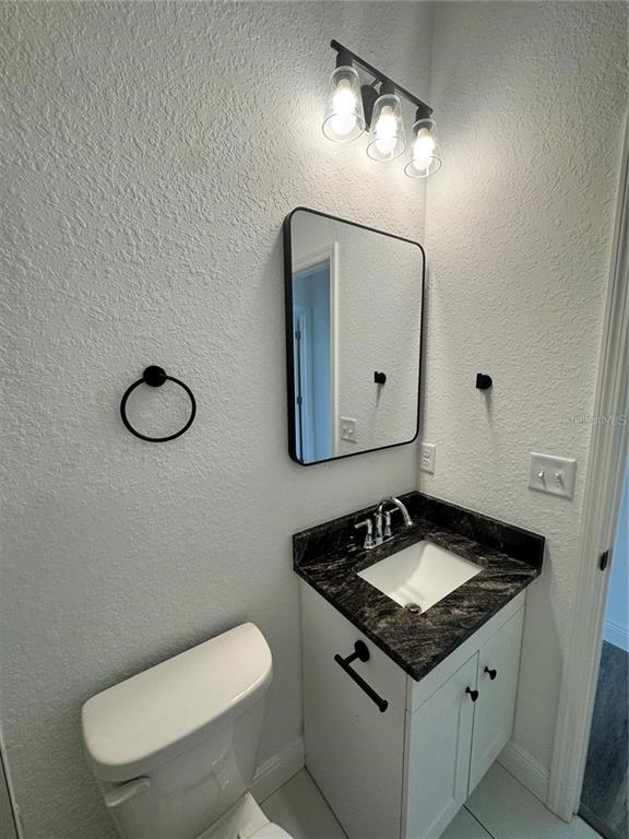 5394 Northwest 6th Place Ocala, FL 34482 - Photo 20 of 42 a bathroom with a toilet a sink and mirror