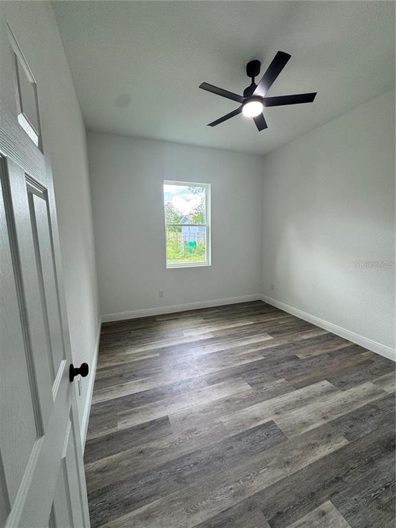 5394 Northwest 6th Place Ocala, FL 34482 - Photo 21 of 42 a view of an empty room with wooden floor and a window