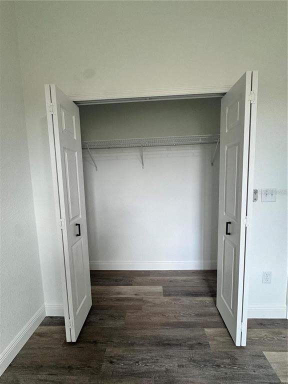 5394 Northwest 6th Place Ocala, FL 34482 - Photo 23 of 42 an empty room with wooden floor and closet