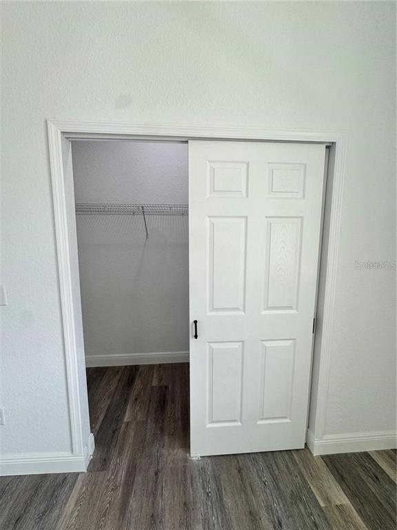 5394 Northwest 6th Place Ocala, FL 34482 - Photo 30 of 42 an empty room with wooden floor and closet