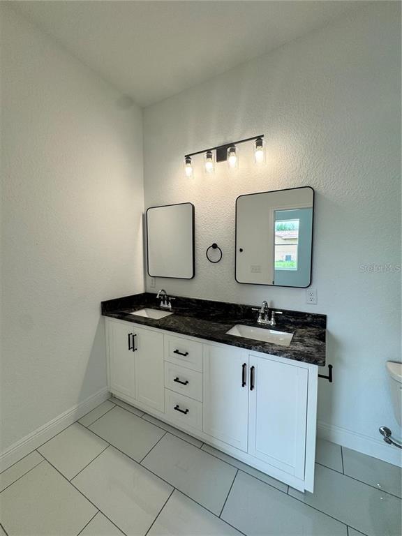 5394 Northwest 6th Place Ocala, FL 34482 - Photo 32 of 42 a bathroom with a granite countertop sink and a mirror