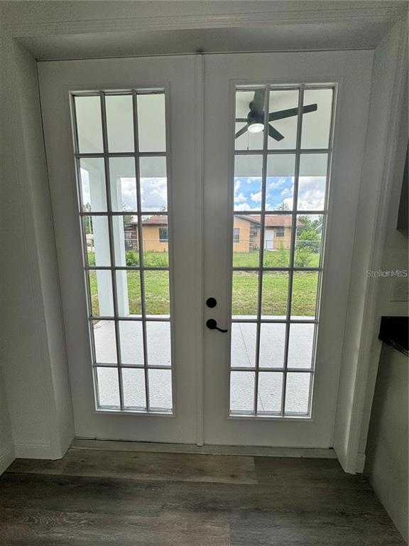 5394 Northwest 6th Place Ocala, FL 34482 - Photo 10 of 42 an empty room with wooden floor and windows