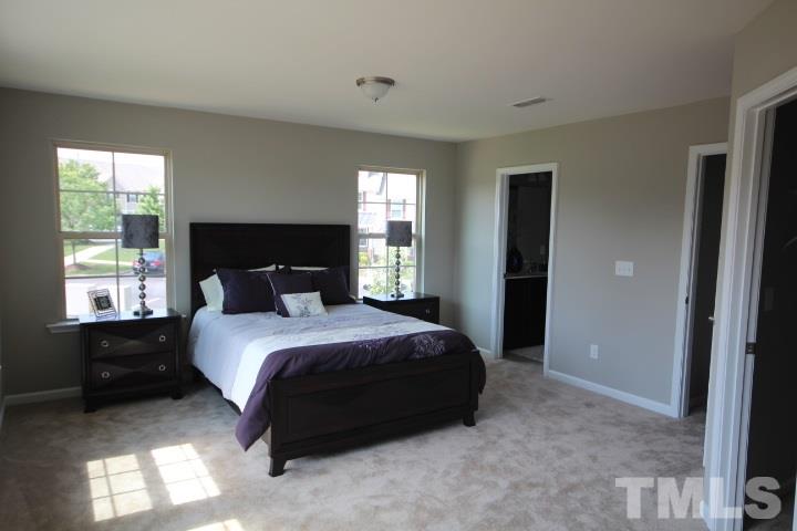 1019 Grand Ridge Drive Rolesville, NC 27571 - Photo 15 of 25 a bedroom with a bed and a window