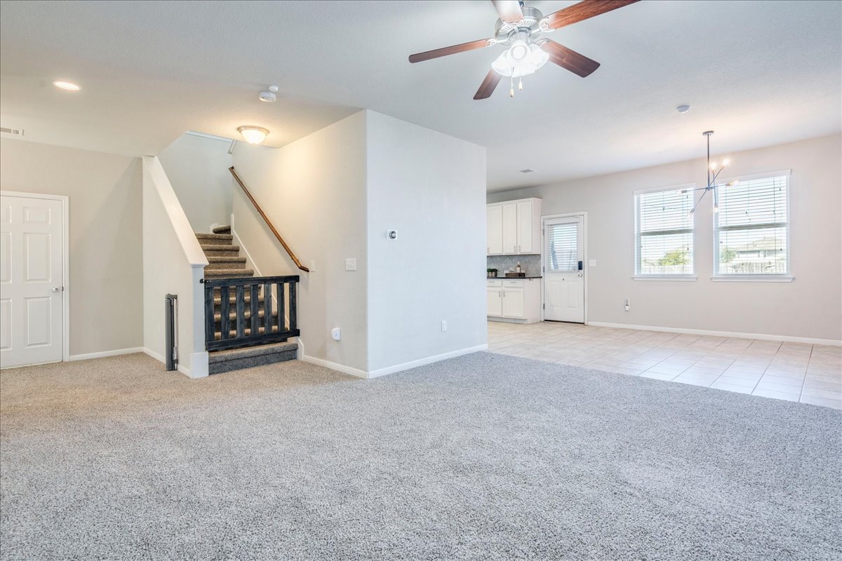 312 Triumph Road Buda, TX 78610 - Photo 12 of 37 The living room is open to the kitchen and dining. Brand new carpet!!