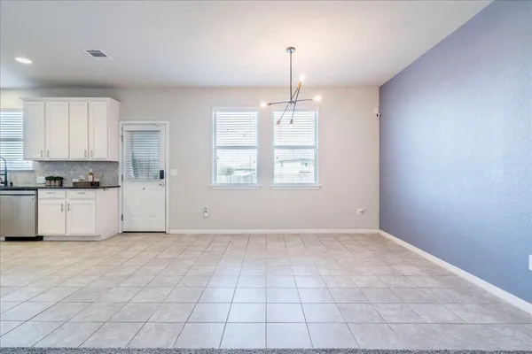 a kitchen with granite countertop white cabinets stainless steel appliances and a sink