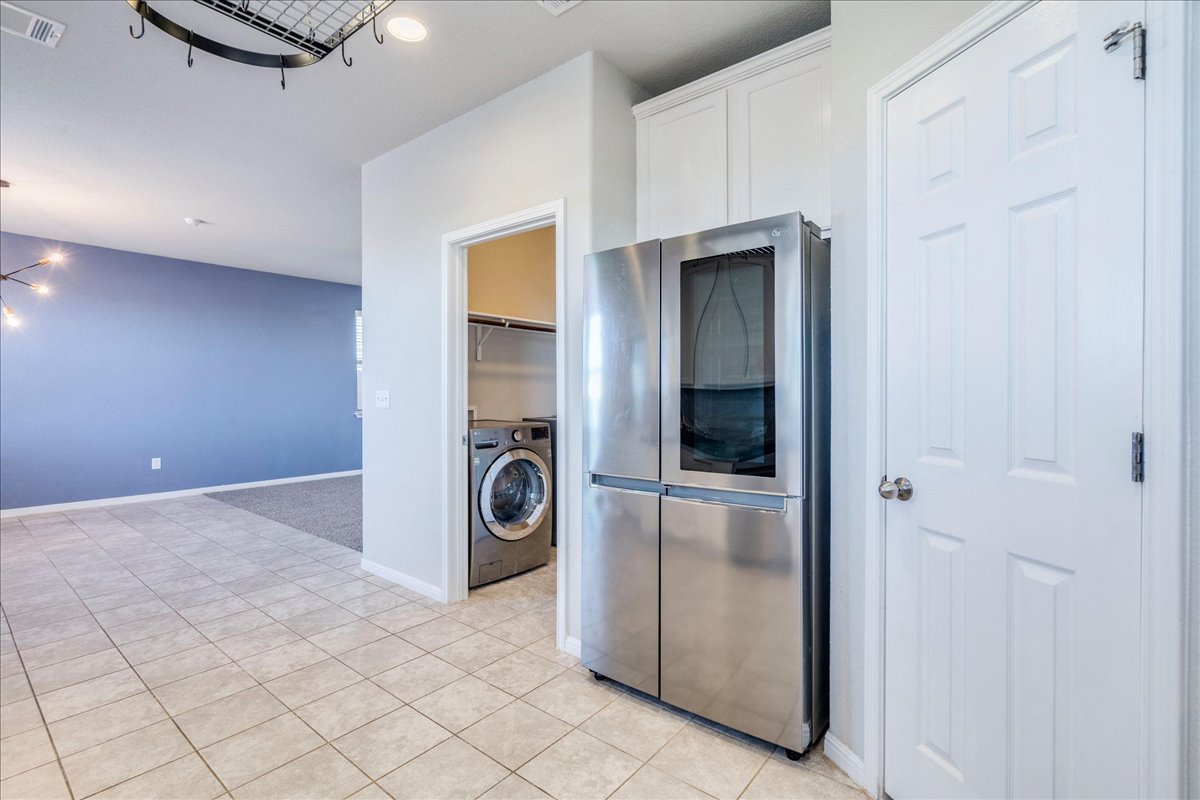 312 Triumph Road Buda, TX 78610 - Photo 18 of 37 Kitchen features upgraded stainless appliances, granite countertops, 42" white cabinetry and upgraded large farmhouse sink! Refrigerator will convey.