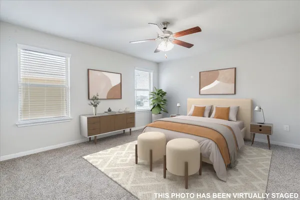 a bedroom with a bed and ceiling fan