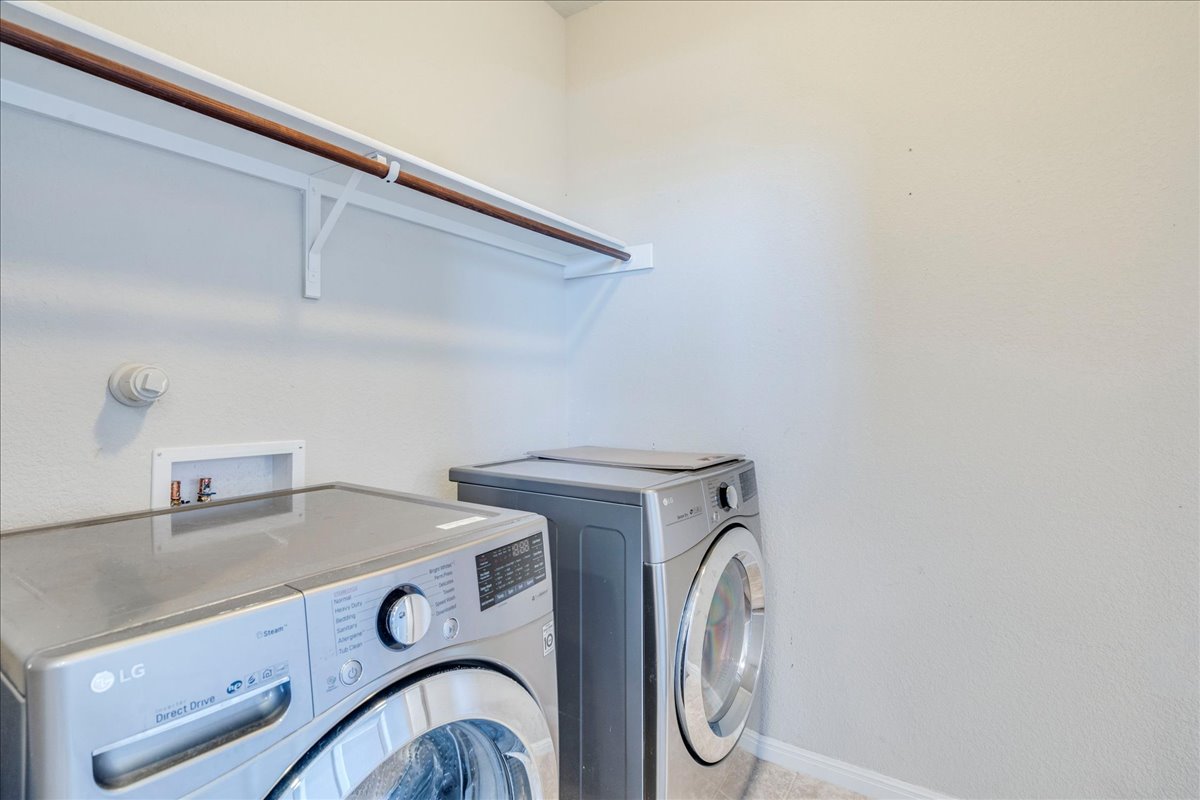 312 Triumph Road Buda, TX 78610 - Photo 32 of 37 Downstairs laundry room that features a large walk-in storage closet under the stairs. Washer/dryer do not convey.
