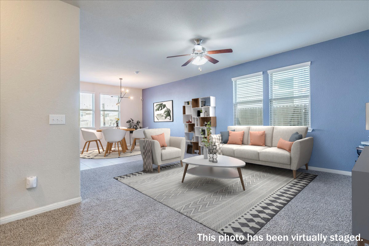 312 Triumph Road Buda, TX 78610 - Photo 7 of 37 Virtually staged. The living room is open to the kitchen and dining. Brand new carpet!!