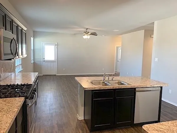 a kitchen with a sink stove and cabinets
