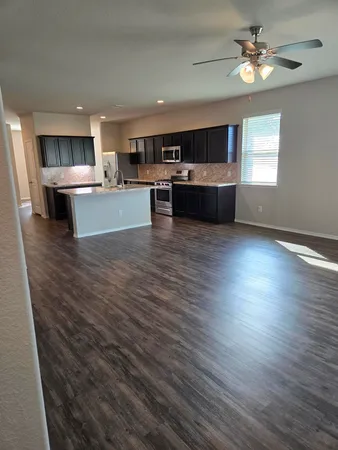a view of kitchen with cabinets and wooden floor