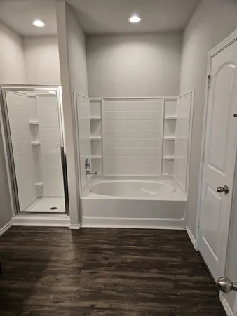 a view of room with wooden floor and staircase