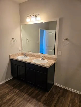 a bathroom with a sink vanity and mirror