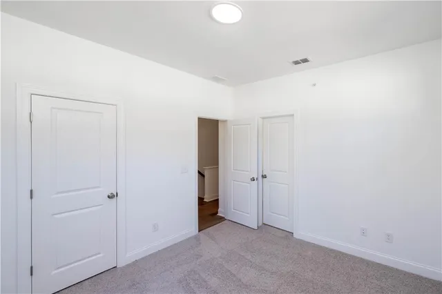 an empty room with closet area