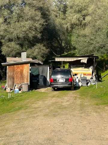 a view of a car is parked in the yard