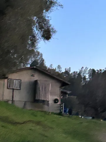a backyard of a house with table and chairs