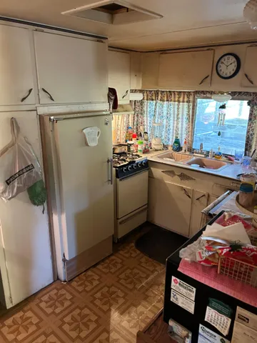 a kitchen with a sink appliances and cabinets