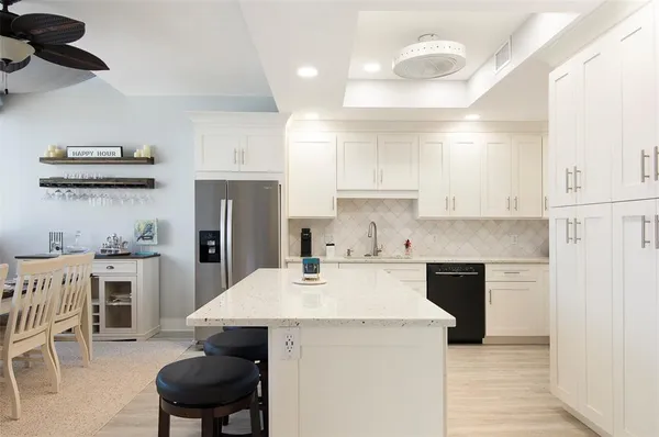 a kitchen with a sink a stove and chairs